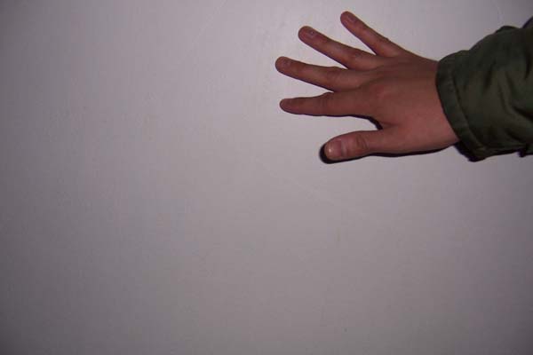 Hand touching wall