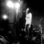 black and white shot of Edie Brickell on stage