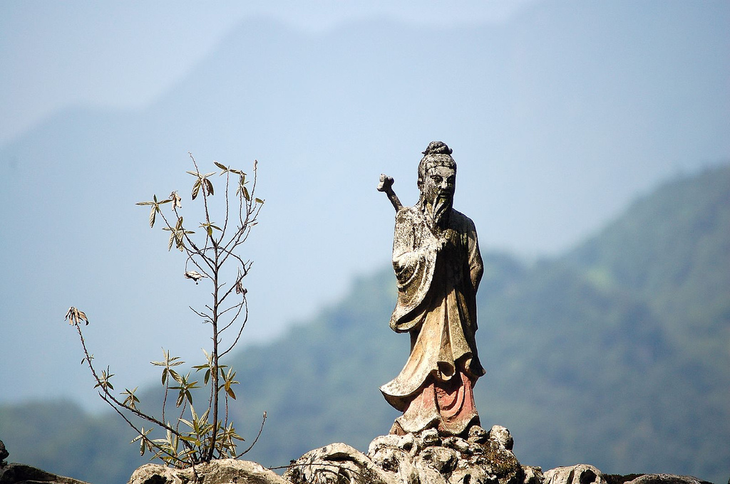 image of small stone statue of a Tao warrior on a Taoist temple in china