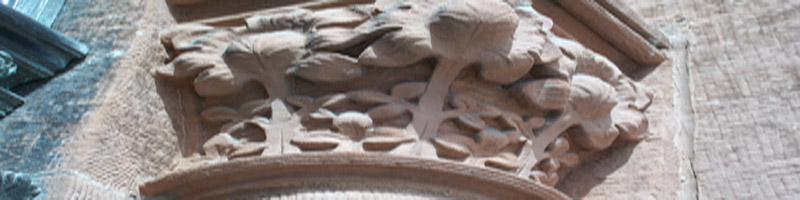 Carving of stone flowers atop a column in high relief
