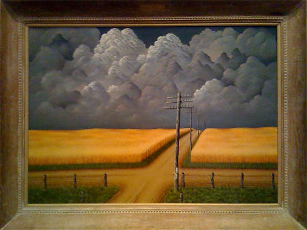 Landscape with dark storm clouds over fields of golden wheat
