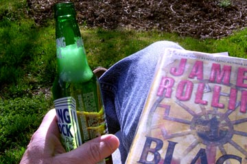 Rolling Rock and shitty novel, enjoying a sunny day