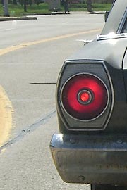 Taillight of old Ford seen through my windshield