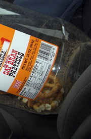 Big container of pretzels on car seat