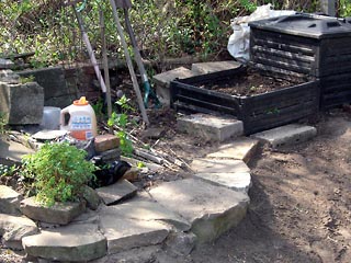 New stone wall/walk in the garden near compost bin