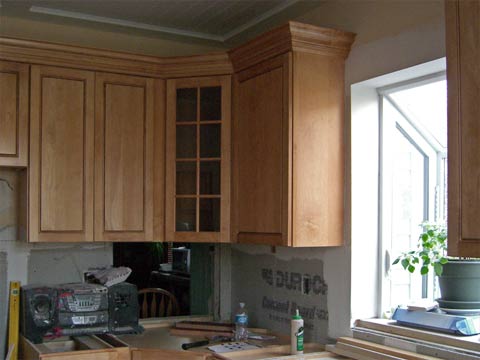 View of kitchen cabinets showing crown molding