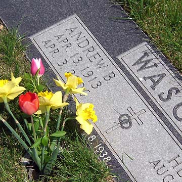 Headstone on Dad's grave, flowers in front