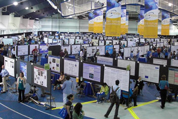 Overview of field house with hundreds of posters