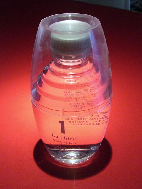 Glistening water bottle on red background