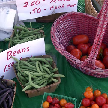 Fresh beans and tomatoes on table
