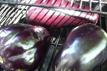 Three eggplants on the grill
