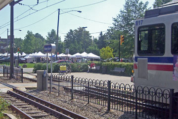 View of Shaker Square with market tents, Rapid car in foreground