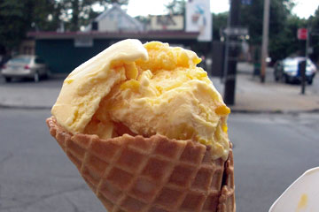 Mango ice cream in a waffle cone