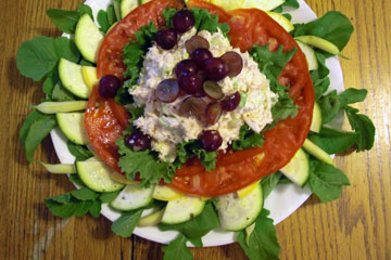 Salad greens, tomatoes, etc. arranged on plate
