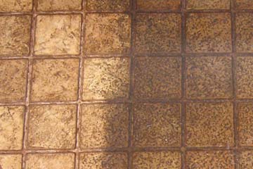 Photo of kitchen floor with light clean area on left, dark dirty area on right