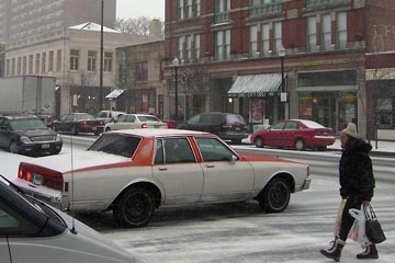 Snow and traffic on West 25th at Bridge Ave.