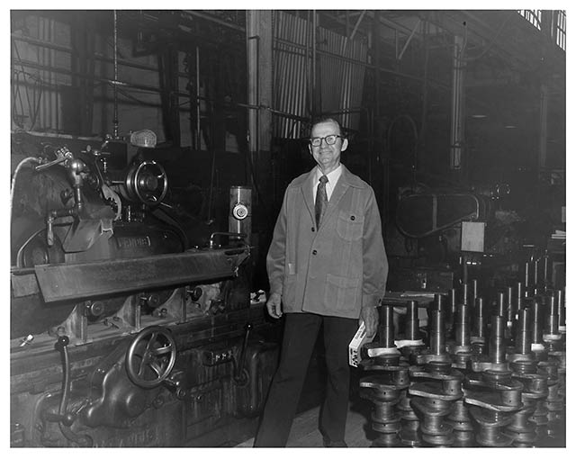 Dad standing next to his grinder at Ohio Crankshaft