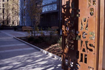 Metal gate sculpture by Tom Otterness at CPL Eastman Reading Garden