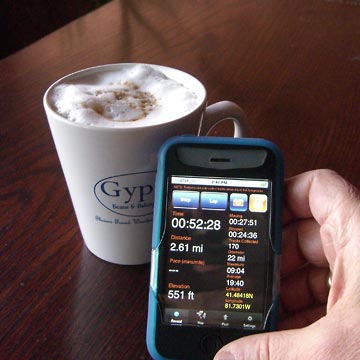 Cup of coffee and iPhone on table