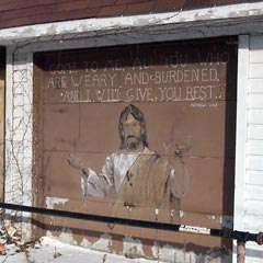 Garage door with Bible verse and portrait of Jesus painted on it