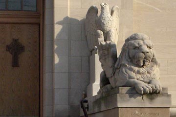 Carved stone eagle and lion at front of St. Colman's