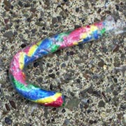 Multi-colored candy can on sidewalk