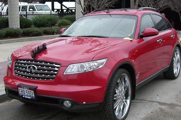 Bright red car with Mohawk type hood ornament