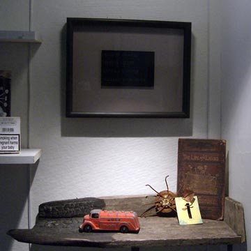 Driftwood shelf with toy truck and other objects on it