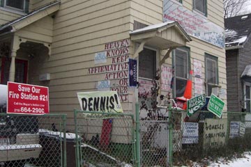House with political signs and slogans all over it