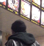 Menu board and people at Chinese restaurant