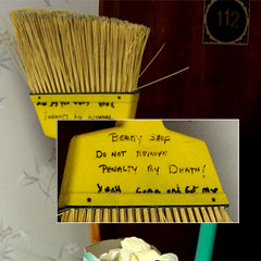 Broom with "Do Not Remove" threat written on it