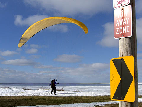 Hang glider at edge of cliff 