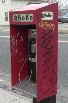 Phone booth with word modified to say 'broke'