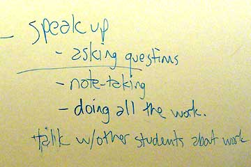 Notes on white board about student participation
