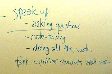 Notes on white board about student participation
