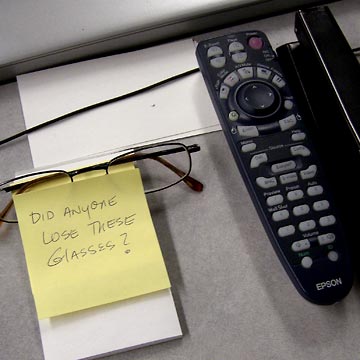 Glasses on desk with note