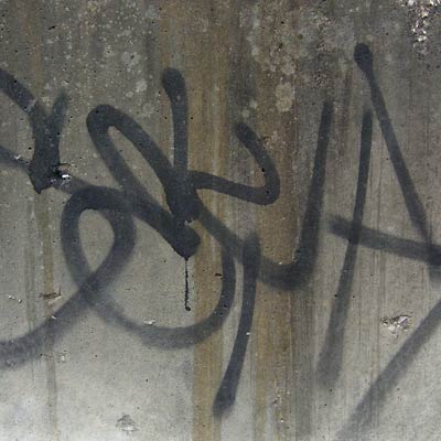 Cleveland graffiti, black spray paint on streaked concrete