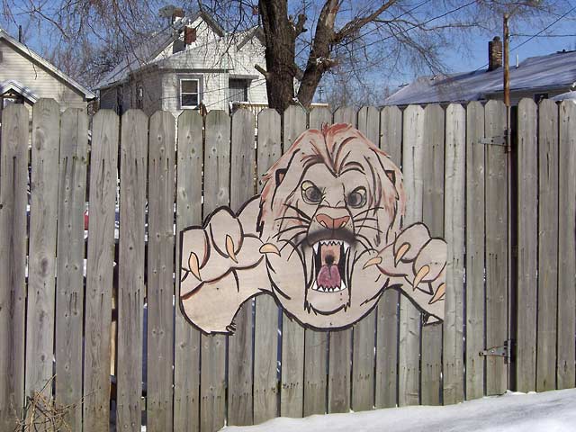 Painting a fierce dog on fence