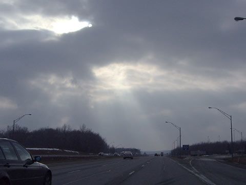 Sun breaking through clouds over I-71 South