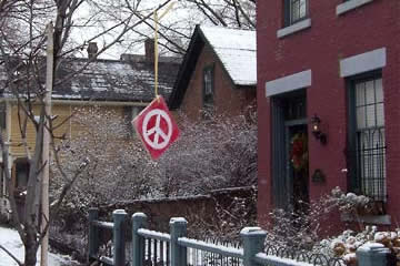 Peace sign hanging from tree branch on Bridge Ave.