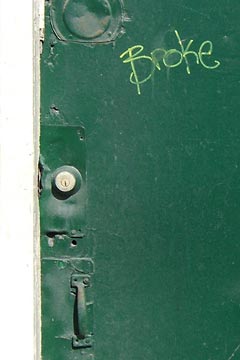 Green door with the word Broke written on it