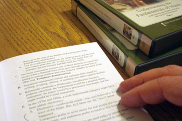 Book and boxes of CDs on table