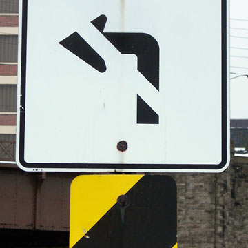 Road sign, arrow and warning