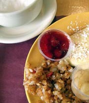 Looking down at coffee and blintzes on a plate