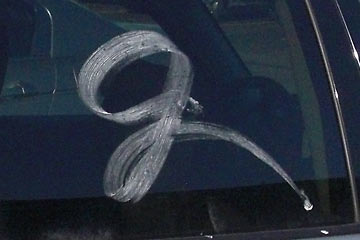 White calligraphic letter on car window