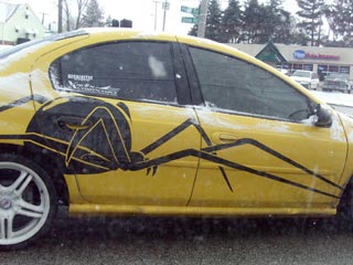 Yellow car with black widow graphic