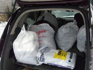 PIles of clothes in the back of car