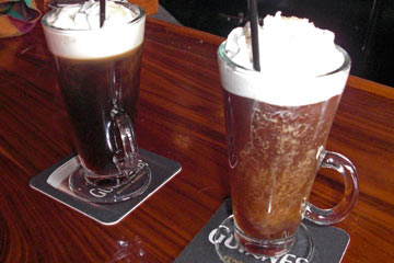 Two Irish coffees in glass mugs