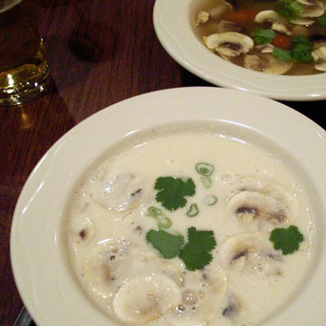 Two bowls of soup on table