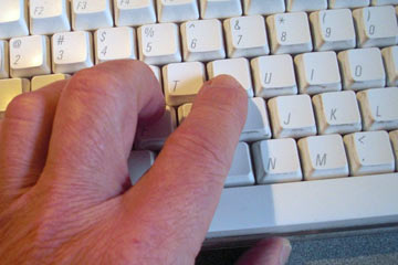 Hand typing on keyboard